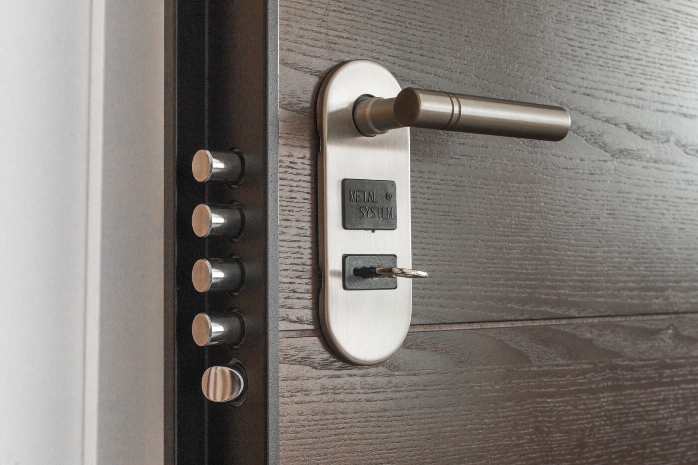 Quality Home Services technician repairing a door lock in a Tampa-area home